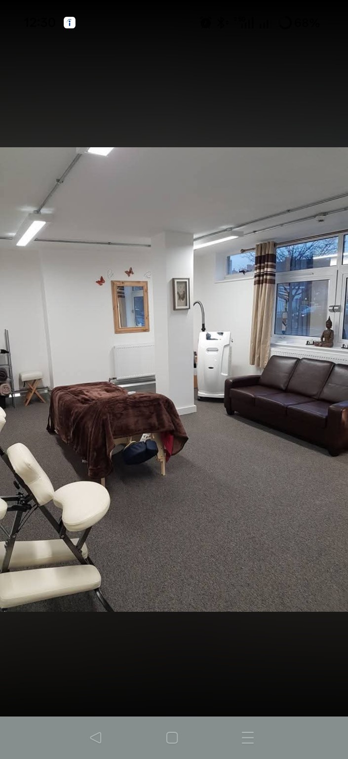Burlington House treatment room with a massage table, cryotherapy machine and seating
